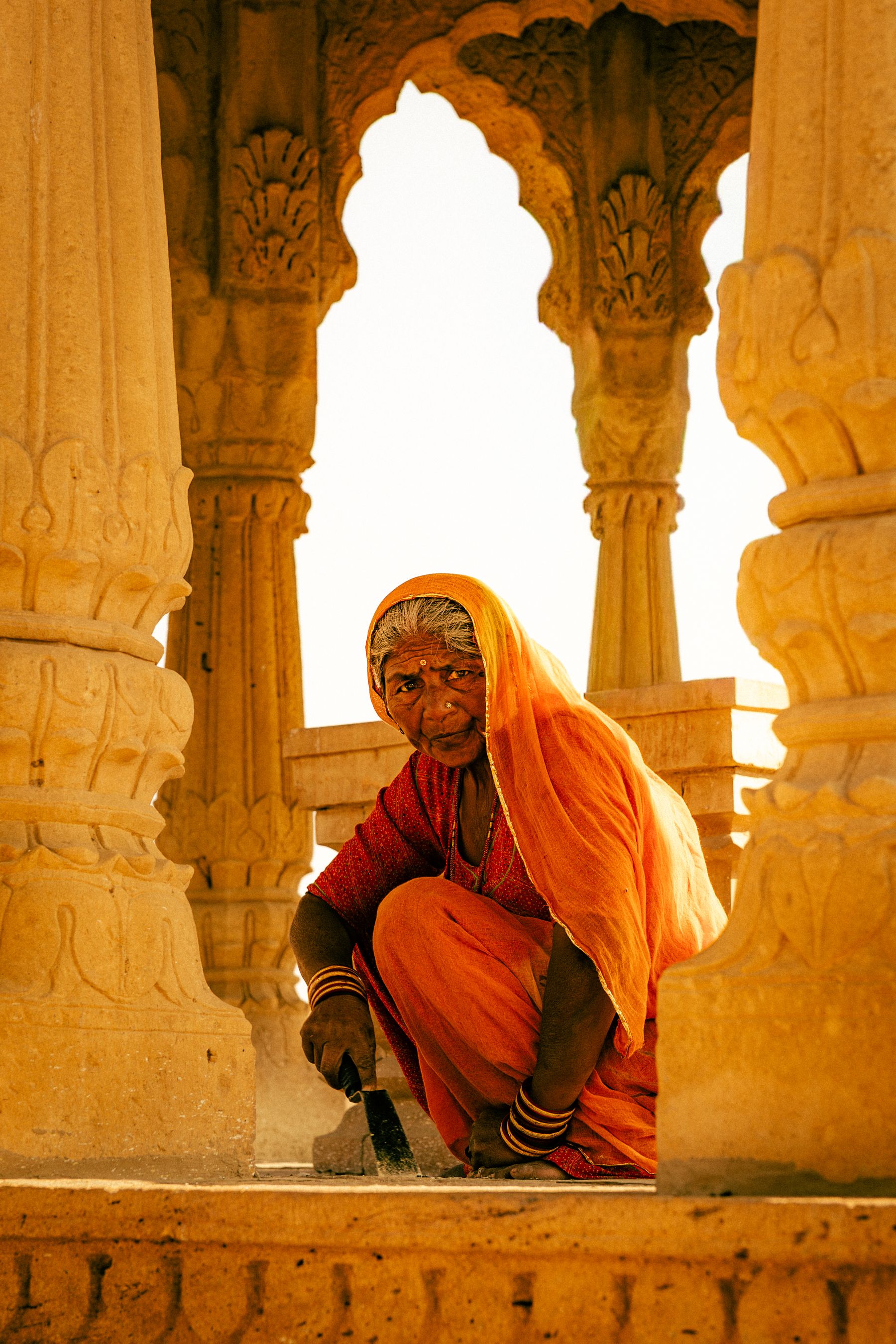 Woman In Orange Seated In A Bada Bagh Arch